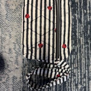 Lug Black and White Striped Crossbody Bag with Red Accents